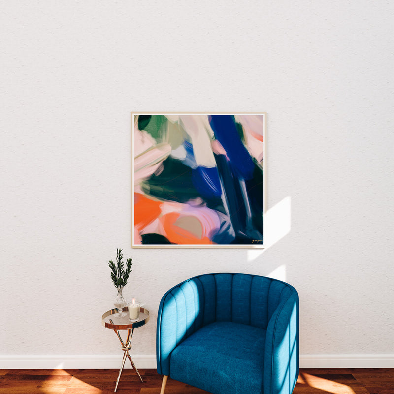 Anemone, bright blue and orange color abstract wall art print over blue accent chair in living room decor - Parima Studio
