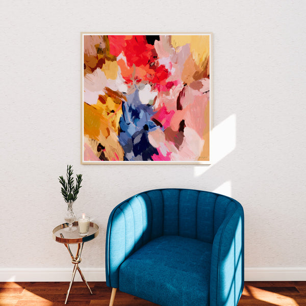 Daphne, bright multicolor abstract wall art print over blue accent chair in living room decor by Parima Studio - artist Patricia Vargas 